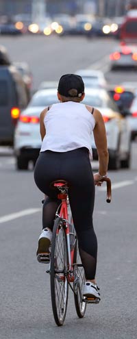 Cyclist sharing road with cars